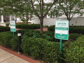 green vehicle parking only signs
